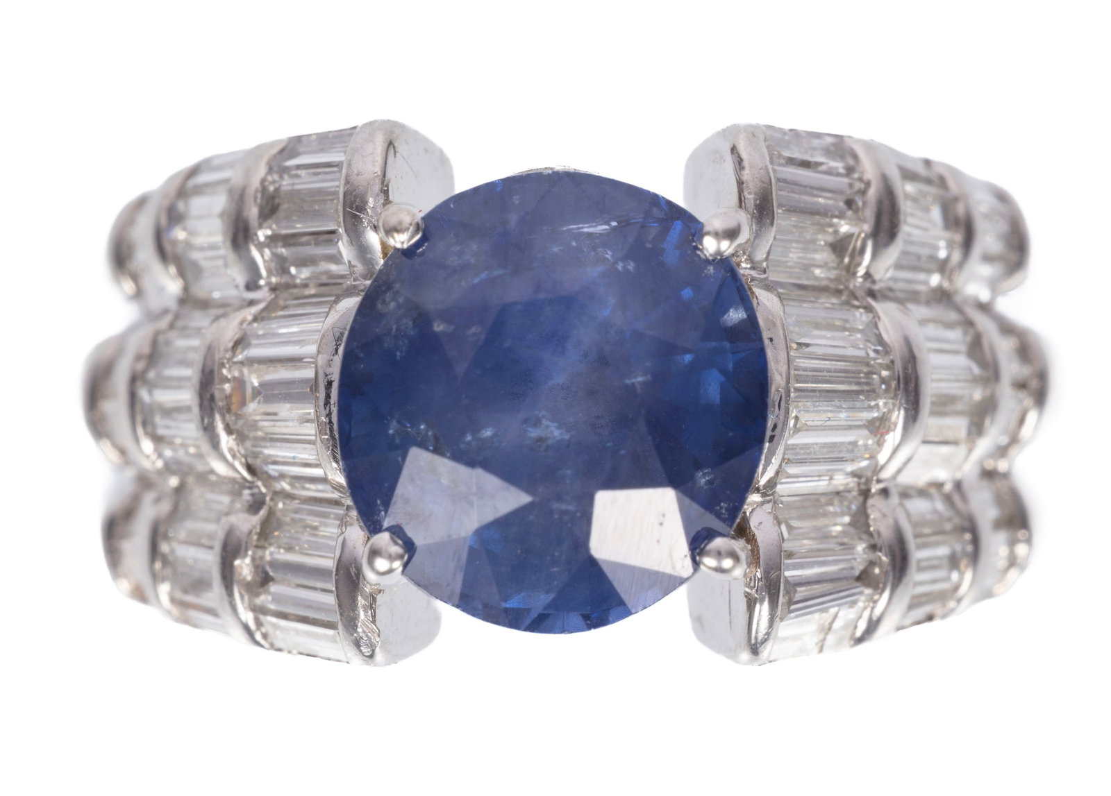 Platinum, Ceylon Sapphire and Diamond Ring: Platinum, Ceylon Sapphire and Diamond Ring center oval brilliant faceted cut blue sapphire, wt. approx. 4.60 cts.; mounted with 1.00 ct. of baguette cut diamonds; size 6; GGA report. Please Note: Paym