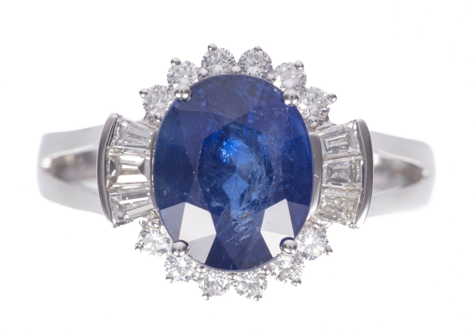 Platinum, Sapphire and Diamond Ring: Platinum, Sapphire and Diamond Ring center oval brilliant faceted cut blue sapphire, wt. approx. 4.32 cts.; mounted with 6 baguette and 12 round brilliant cut diamonds, total wt. approx. 0.57 ct.; siz