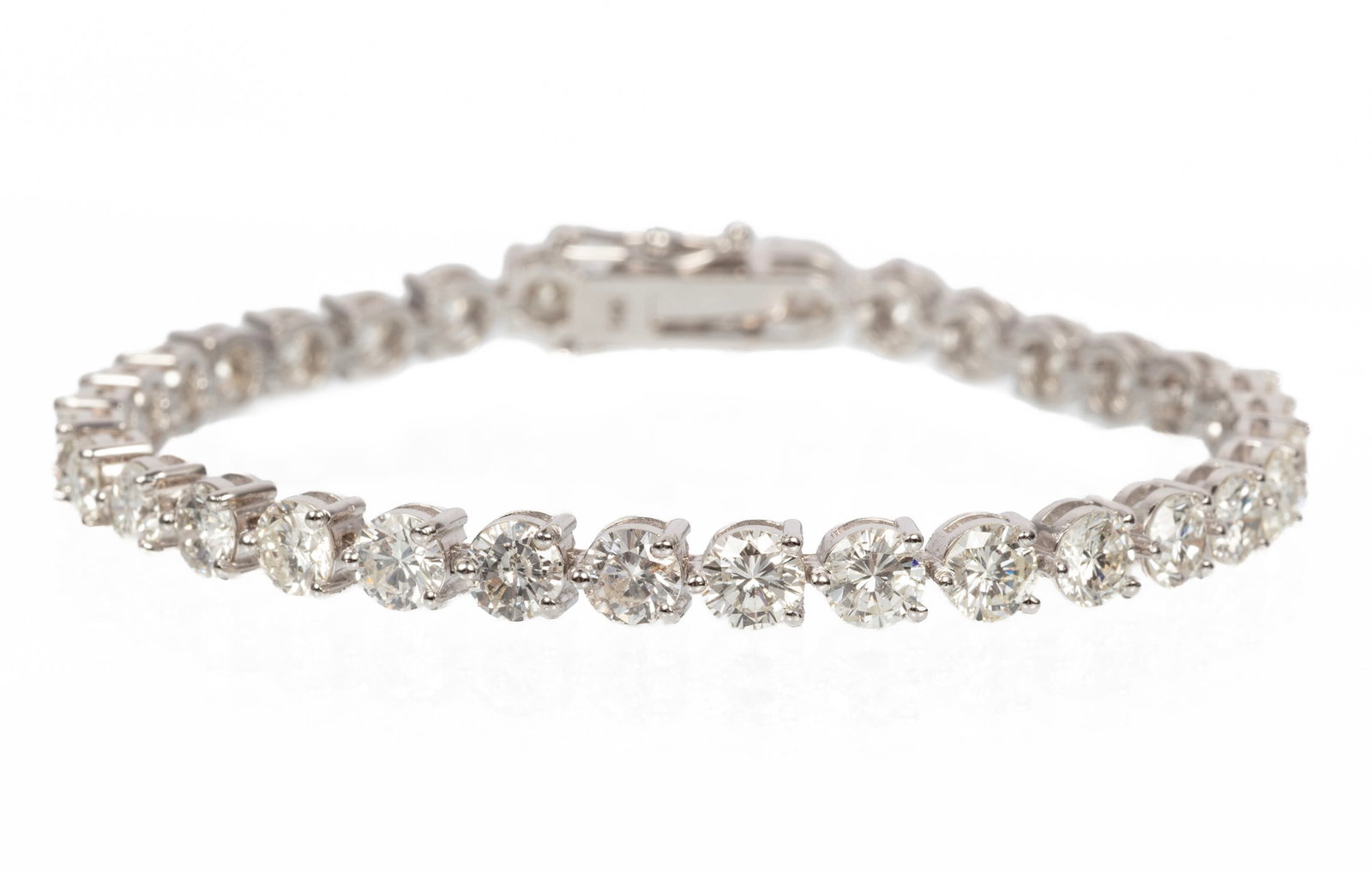 14 kt. White Gold and Diamond Tennis Bracelet: 14 kt. White Gold and Diamond Tennis Bracelet mounted with 11.75 cts. of round brilliant; l. 7 in.; 9.42 dwts. Please Note: Payment for all jewelry and all couture items MUST be made by cash, check or