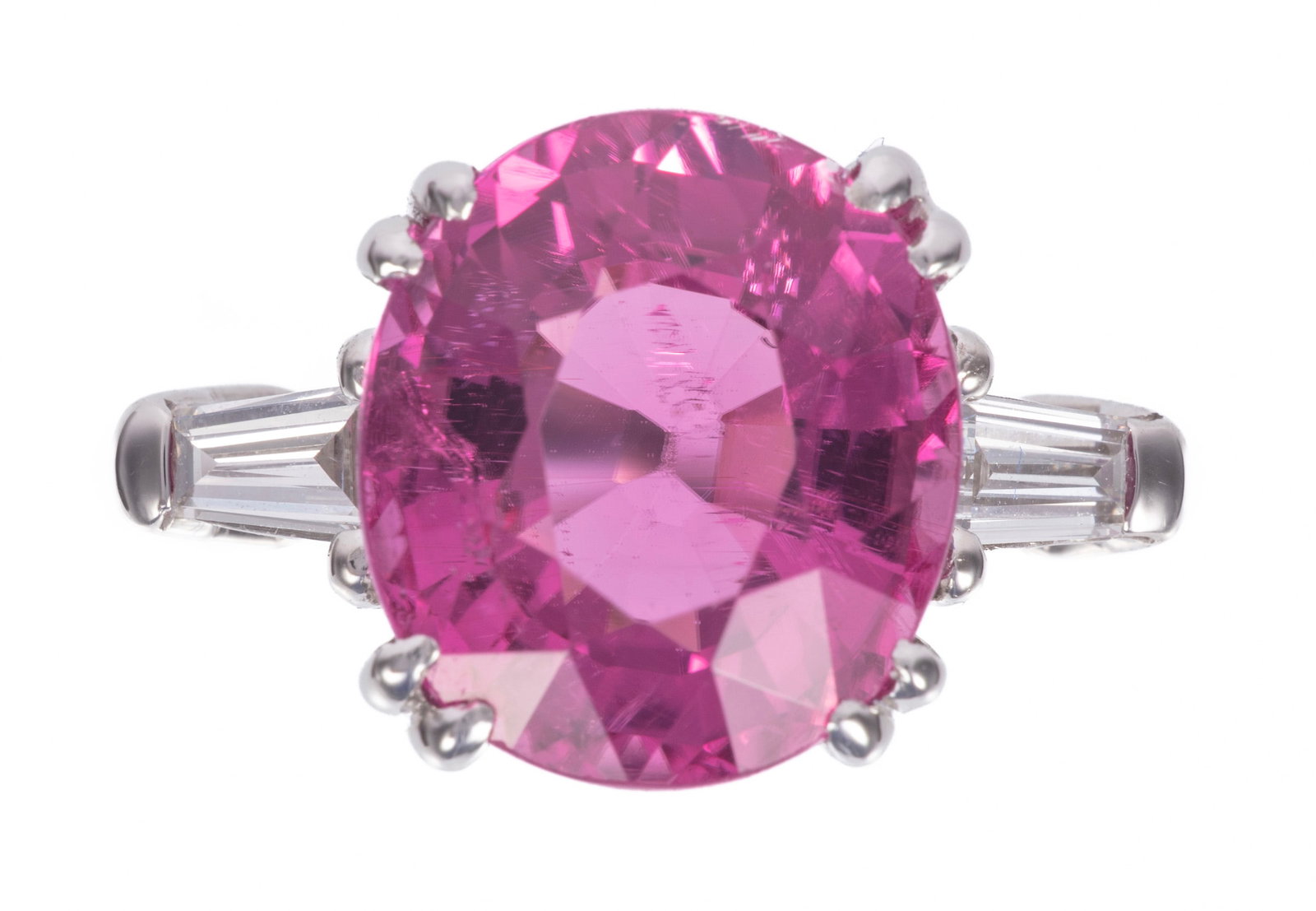Platinum, Rubellite Tourmaline and Diamond Ring: Platinum, Rubellite Tourmaline and Diamond Ring center oval brilliant faceted cut rubellite tourmaline, wt. approx. 5.76 cts.; mounted with 2 baguette cut diamonds, total wt. approx. 0.30 ct.; size