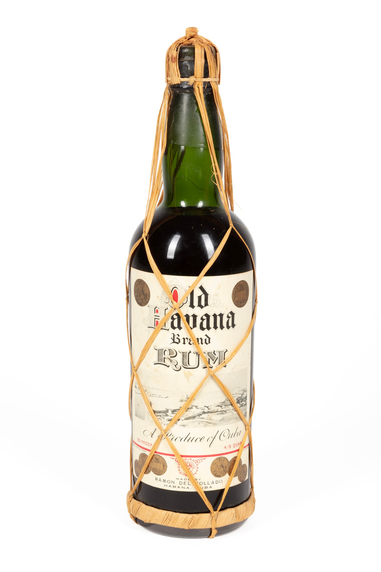 Ramon del Collado Old Havana Brand Cuban Rum: Ramon del Collado Old Havana Brand Cuban Rum 1 bottle, 4/5 qt., bottled c. 1940s, with wicker cage and Cuban tax strip. Please note that all sales of spirits and liquor are sold for in-person