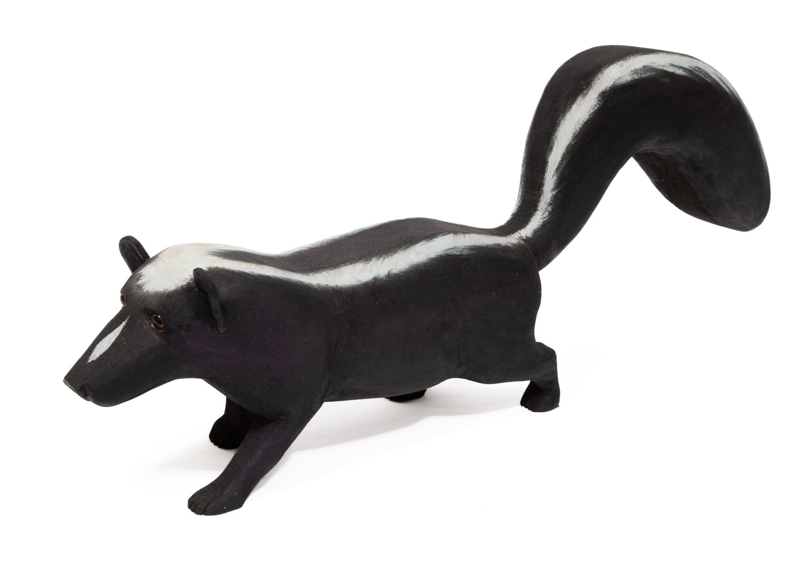Ivy Billiot, United Houma Nation/Louisiana b. 1945, "Skunk", acrylic and glass eyes on carved wood: Ivy Billiot United Houma Nation/Louisiana, b. 1945 "Skunk" acrylic and glass eyes on carved wood 2003, signed and dated on underside. 11 x 27 x 5 in. (27.9 x 68.6 x 12.7 cm.)