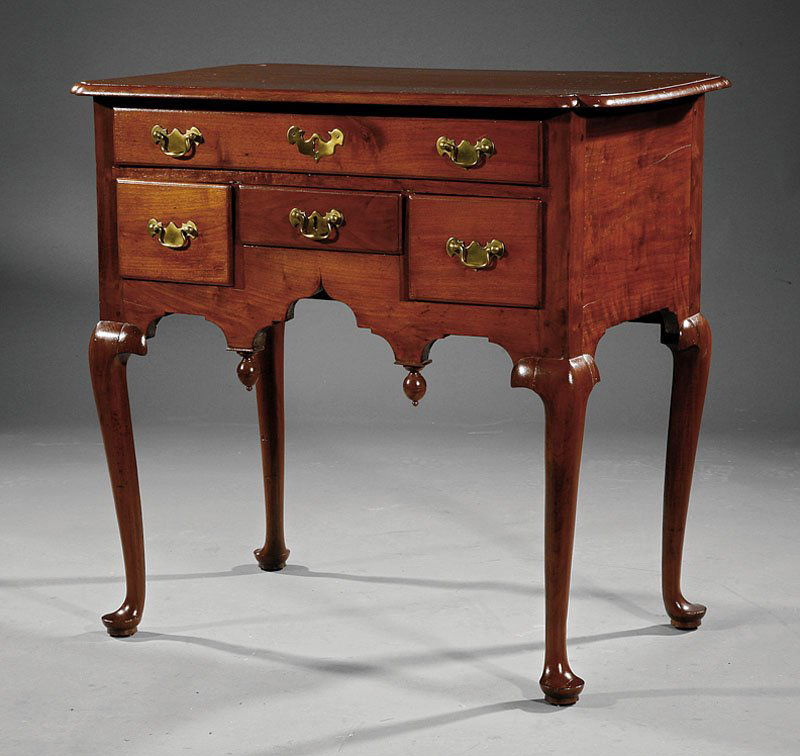 American Queen Anne Carved Walnut Lowboy: An American Queen Anne Carved Walnut Lowboy, mid-18th c., Rhode Island, molded top with notched corners, case fitted with kneehole configuration of drawers, acorn pendants, cabriole legs, pad feet, ch