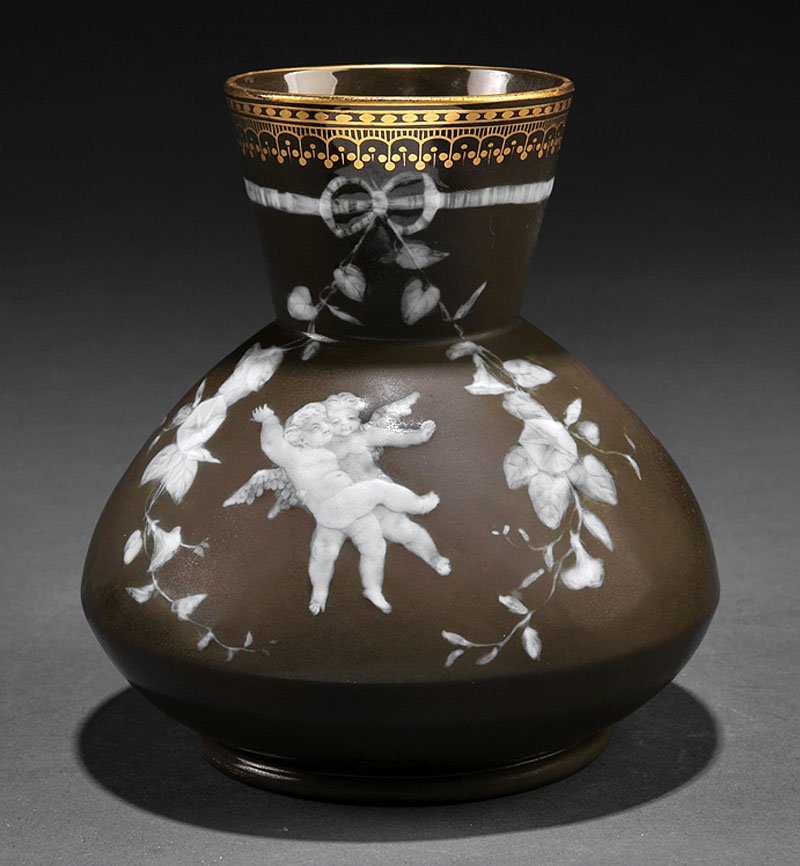 George Jones Pâte-sur-Pâte Vase: A George Jones Pâte-sur-Pâte Vase, late 19th c., olive green ground, decorated with cavorting putti within beribboned morning glory wreaths, gilt decorated rim, base with gilder's number "5665" and 