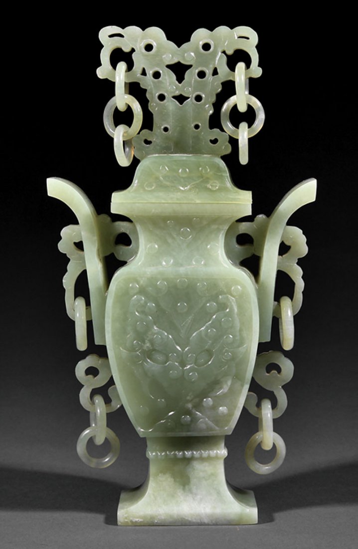 Chinese Celadon Jade Baluster Vase and Cover: A Chinese Celadon Jade Baluster Vase and Cover, body with upright flange handles above scroll handles carved with loose rings, domed cover surmounted by an openwork stylized mask hung with rings, heig