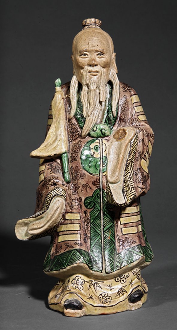 Chinese Famille Verte and Biscuit Glazed Figure: A Chinese Famille Verte and Biscuit Glazed Figure of a Star God, 19th c., standing bearded figure clad in brocade robes and holding a furled flag, height 11 1/4 in. Note: Condition