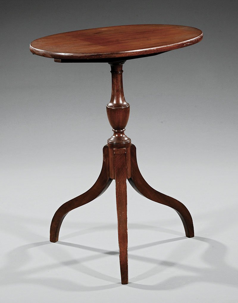 An American Federal Mahogany Tilt-Top Candlestand: An American Federal Mahogany Tilt-Top Candlestand, early 19th c., Baltimore, oval top, vasiform shaft on arched spider legs, height 29 in., width 23 in., depth 17 in