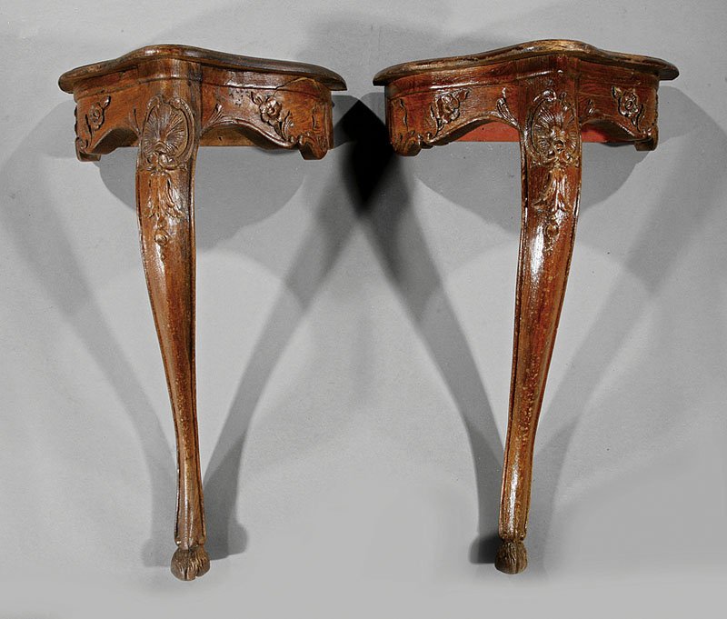 A Pair of Louis XV-Style Carved Oak Consoles: A Pair of Antique Louis XV-Style Carved Oak Consoles, serpentine top, foliate skirts, shell carved cabriole legs, hoof feet, height 29 in., width 18 5/8 in., depth 10 in