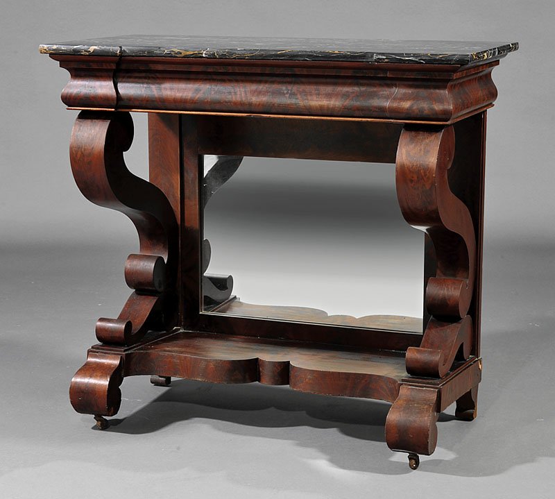 An American Classical Carved Mahogany Pier Table: An American Classical Carved Mahogany Pier Table, early 19th c., Egyptian marble top, block corners, scrolled supports, mirrored back, shaped plinth, scrolled feet, casters, height 39 in., width 42 1/