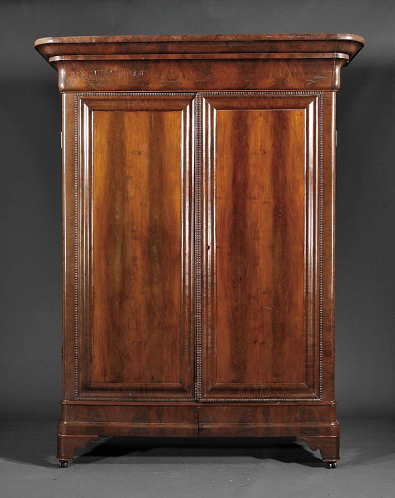 An American Late Classical Mahogany Armoire: An American Late Classical Mahogany Armoire, c. 1830, New Orleans, stepped ogee molded cornice, ripple molded paneled doors, divided interior of shelves, drawers and open compartment, molded plinth ba