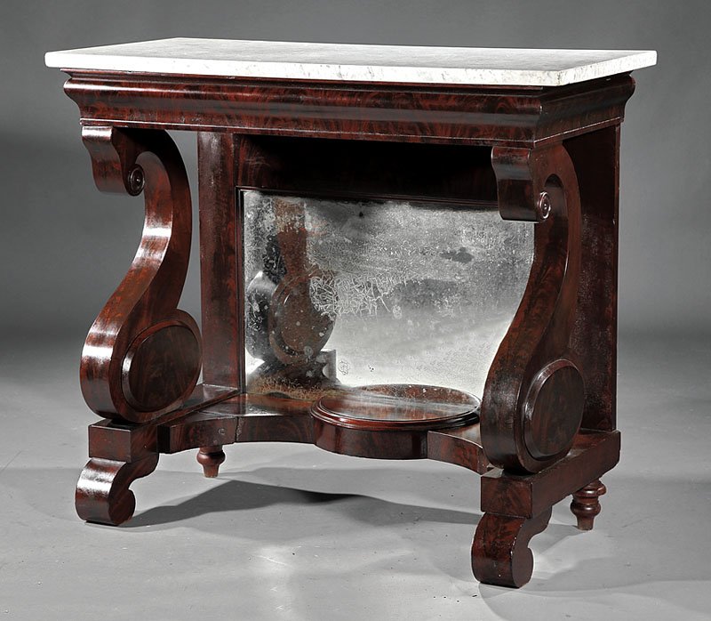 An American Classical Carved Mahogany Pier Table: An American Classical Carved Mahogany Pier Table, early 19th c., Philadelphia, original marble top, ogee molded frieze, scrolled supports, mirrored back, incurvate shelf with demilune center, scroll f