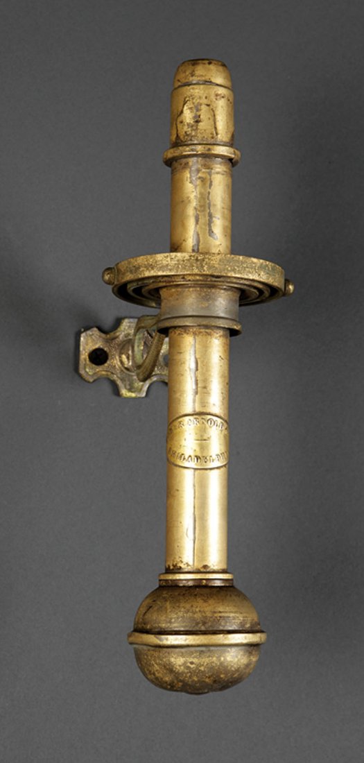 A American Gilt Brass Ship's Gimbal Candlestick: A Rare American Gilt Brass Ship's Gimbal Spring-Loaded Candlestick, c. 1875, Baker Arnold & Co., Philadelphia, labeled, height 10 1/2 in Note: Baker, Arnold & Co. was founded by 1871, after Cornelius