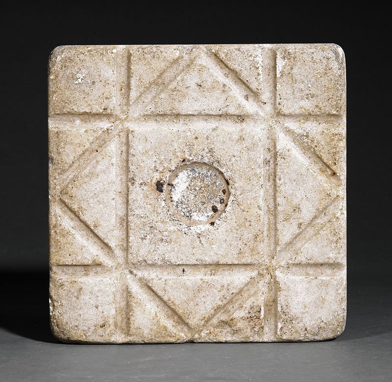 A Marble Hearth Stone: A Marble Hearth Stone, with central depression and incised grooves, length 7 in. Provenance: Acquired from Philip H. Bradley Co., PA, 1984.