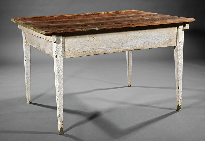 An American Pine Work Table: An American Pine Work Table, early 19th c., associated plank top above a pegged frieze, square tapered legs, height 28 1/4 in., width 45 3/4 in., depth 32 3/4 in. Note: Base with old white-washed surf