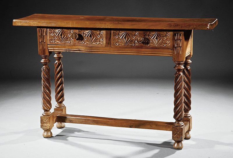 An Antique Continental Carved Walnut Console Table: An Antique Continental Carved Walnut Console Table, probably Iberian, plank top, frieze with two drawers, spiral twist and blocked legs, H stretcher, bun feet, height 3 1/2 in., width 51 in., depth 13