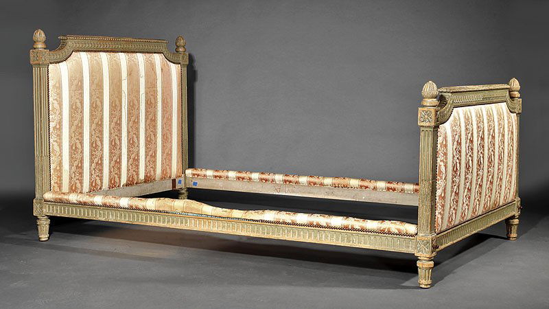 A Louis XVI-Style Creme Peinte Bed: A Louis XVI-Style Creme Peinte Bed, padded headboard, conforming foot board, padded rails, tapered feet, height 42 1/2 in., interior length 80 in., width 48 in