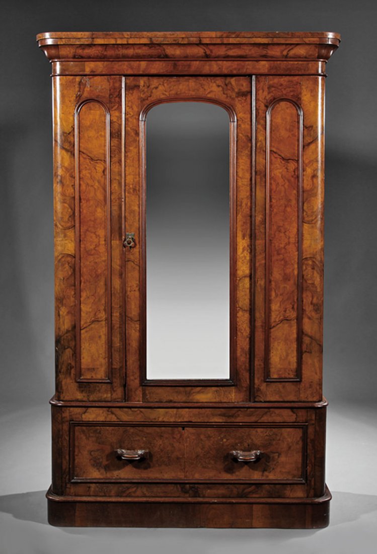 An Edwardian Burl Walnut Armoire: An Edwardian Burl Walnut Armoire, late 19th c., molded cornice above an arched mirrored door flanked by arched panels, drawer below, conforming molded base, height 79 1/2 in., width 48 1/2 in., depth 