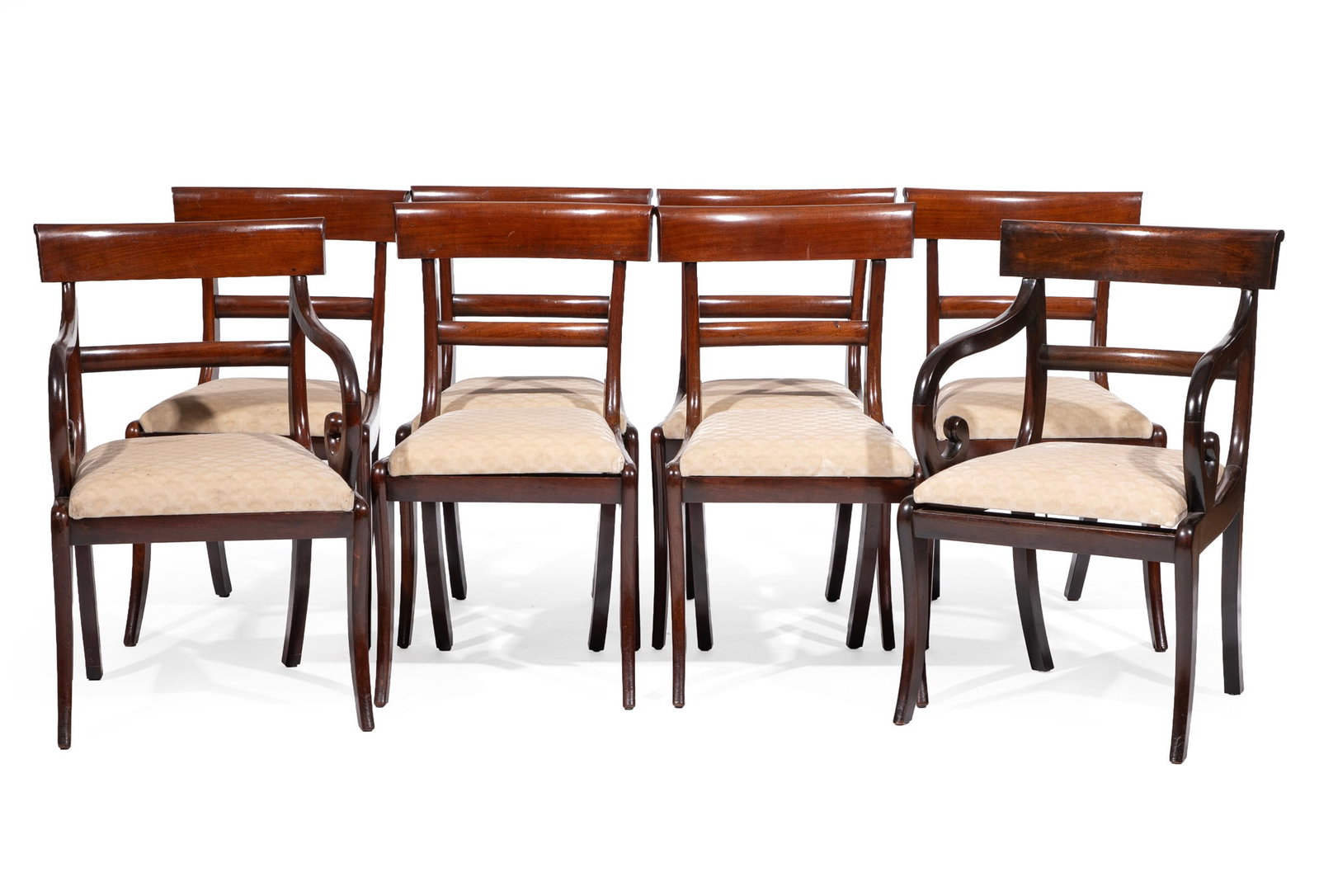 Set of Eight Regency Carved Mahogany Dining Chairs: Set of Eight Regency Carved Mahogany Dining Chairs 19th c., conforming crest rail and back, scroll arms, drop-in seats, sabre legs, consisting of two arms, six sides arm 33 x 20 x 20 in. (83.8 x 50.8