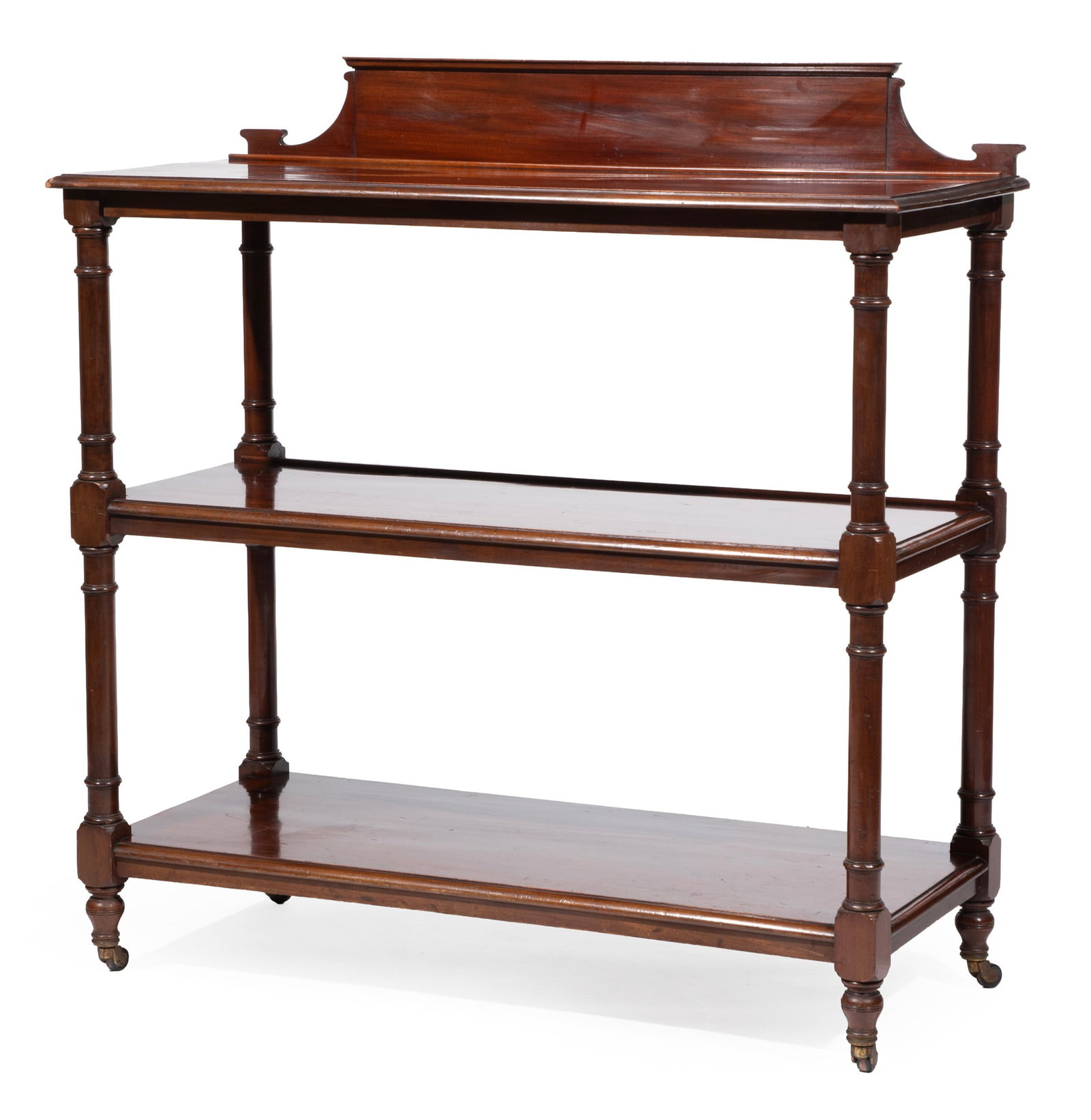 William IV Carved Mahogany Three-Tier Trolley,19th c., labeled SOPWITH & Co NEWCASTLE on TYNE: William IV Carved Mahogany Three-Tier Trolley 19th c., labeled SOPWITH & Co NEWCASTLE on TYNE, shaped backsplash, molded shelves, ring turned supports, turned feet, casters 50 x 48 x 21 in. (127 x 121