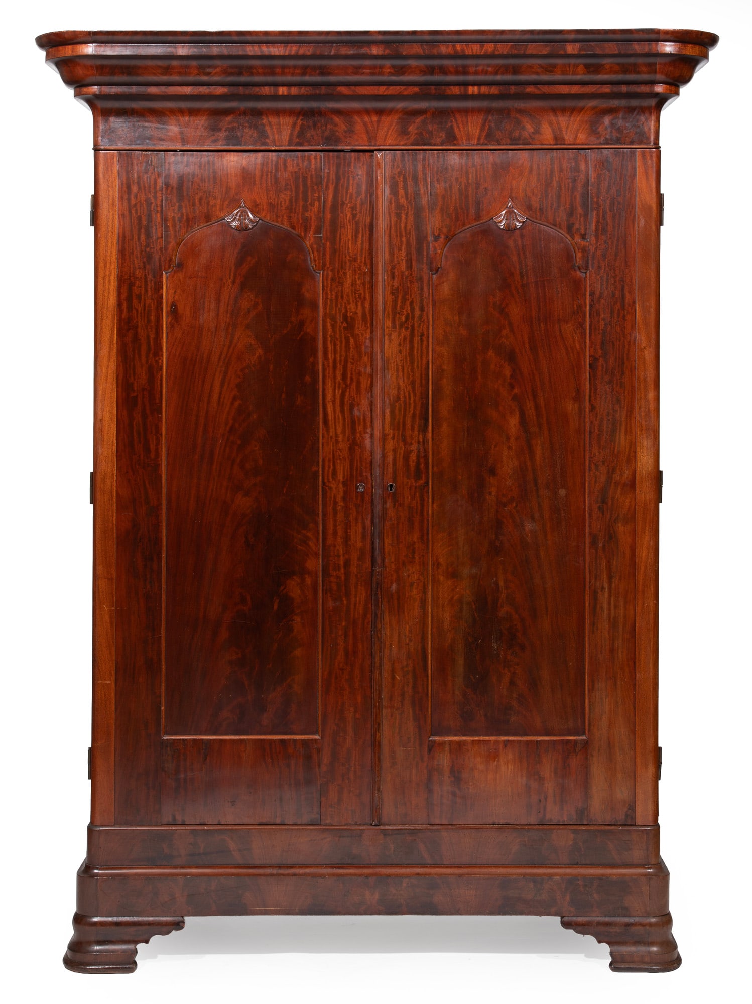 American Rococo Carved Figured Mahogany Armoire, in the manner of Prudent Mallard, New Orleans: American Rococo Carved Figured Mahogany Armoire mid-19th c., in the manner of Prudent Mallard, New Orleans, molded ogee cornice, plain frieze, arched paneled doors, plinth base, ogee bracket feet 98 x