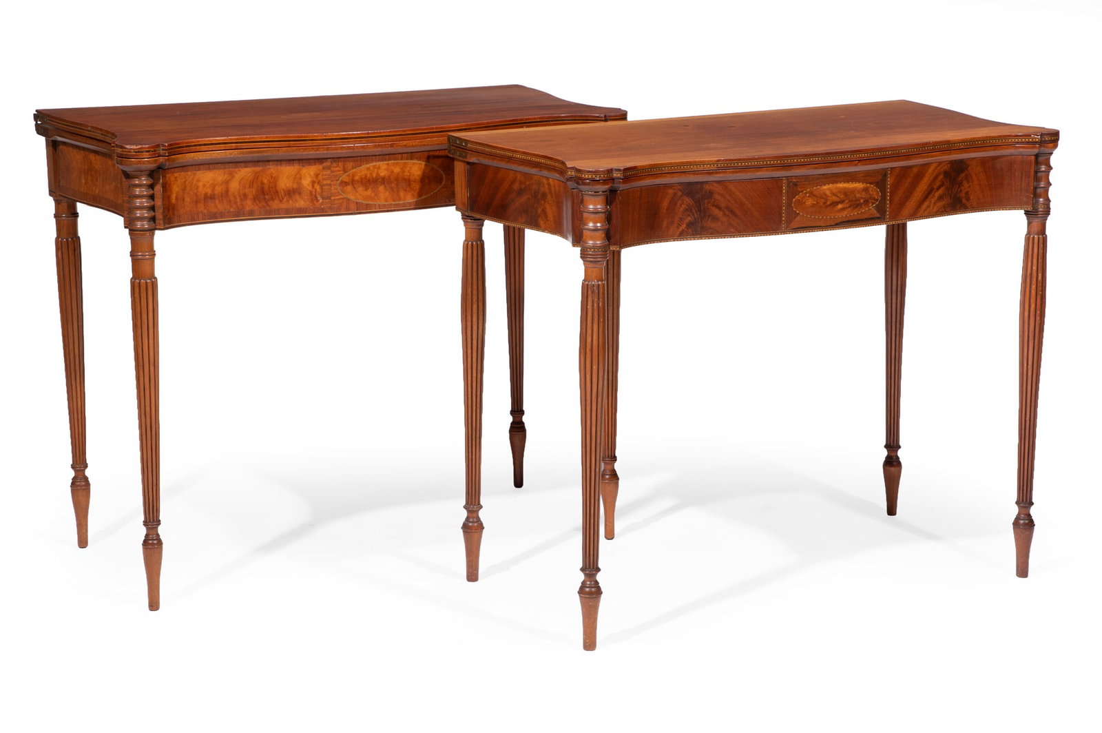 Two American Federal-Style Inlaid Mahogany Games Tables: Two American Federal-Style Inlaid Mahogany Games Tables late 19th/20th c., fold over tops, swing legs, turreted corners, center oval inlaid frieze, ring turned tapered reeded legs open 30 x 35 1/2 x 3