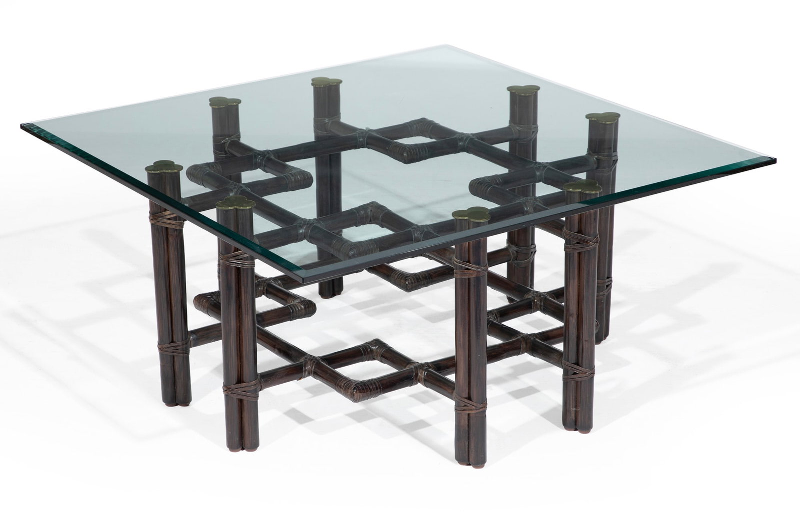 McGuire Hardwood, Brass and Glass Coffee Table: McGuire Hardwood, Brass and Glass Coffee Table 1970s, metal tag of McGuire, San Francisco, Model 66S, turned hardwood, bound with rawhide, with trefoil brass leg caps, beveled glass top Ref. McGuire C