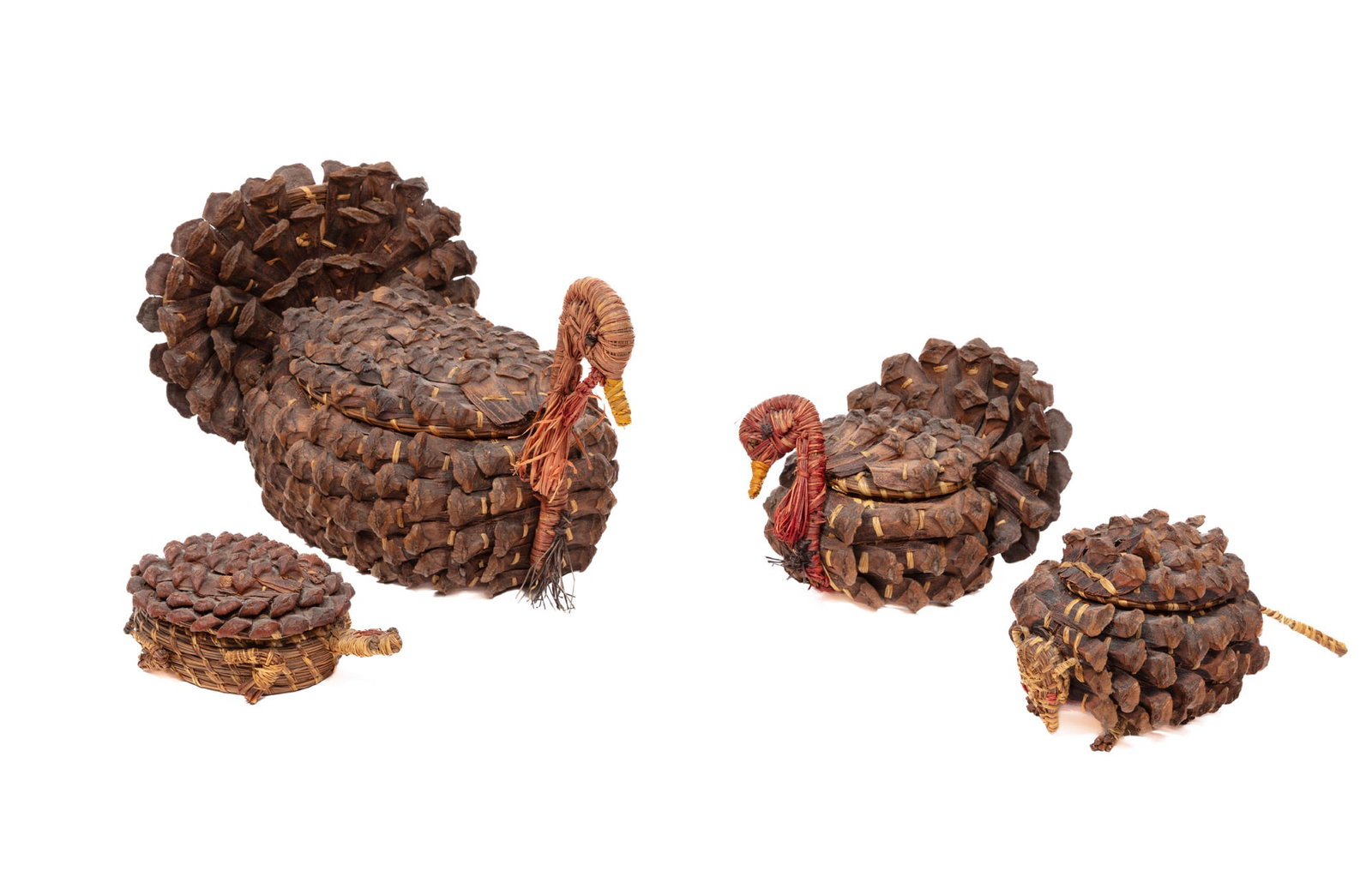 Four Lorena Langley Coushatta-Style Figural Lidded Effigy Baskets: Four Lorena Langley Coushatta-Style Figural Lidded Effigy Baskets , accompanied by two maker tags from the Coushatta Indian Cultural Center; pine cone and dyed and natural pine needles, raffia, and pi