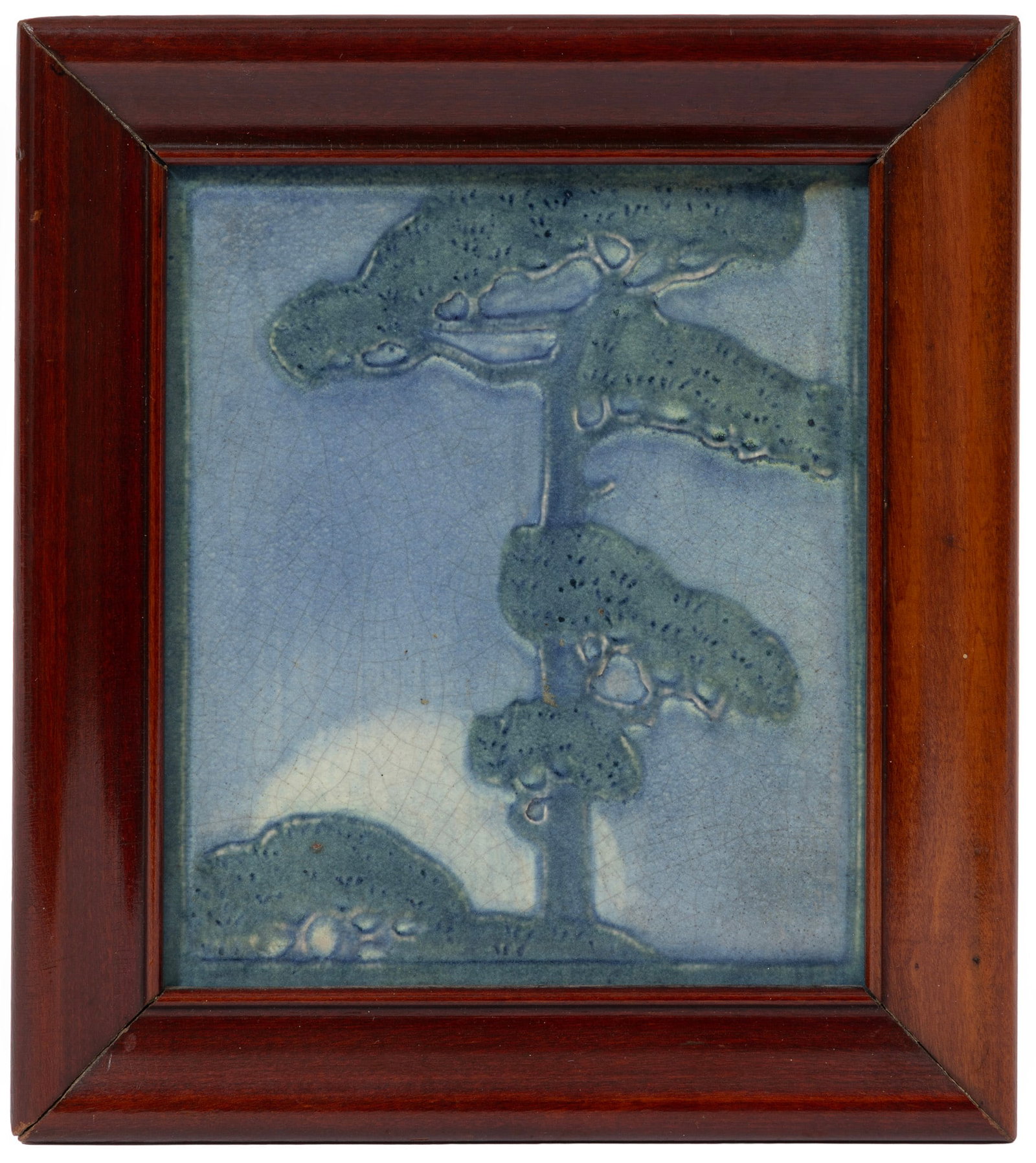 Newcomb College Art Pottery Plaque: Newcomb College Art Pottery Plaque 1912, decorated with low relief-carved pine tree, matte glaze with green, blue and yellow underglaze, reg. no. FK85 to back, tile 6 1/4 in. x 5 1/4 in., frame 8 in. 