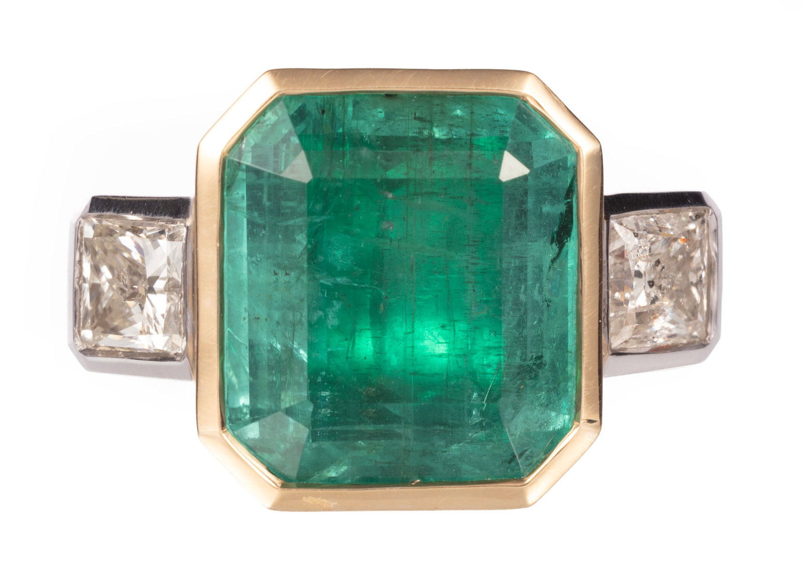 18 kt. Two Tone Gold, 14.20 carat Emerald and Diamond Ring: 18 kt. Two Tone Gold, Emerald and Diamond Ring center GIA certified bezel set octagonal step cut emerald, wt. approx. 14.20 cts.; mounted with 2 square modified brilliant cut diamonds, total wt.