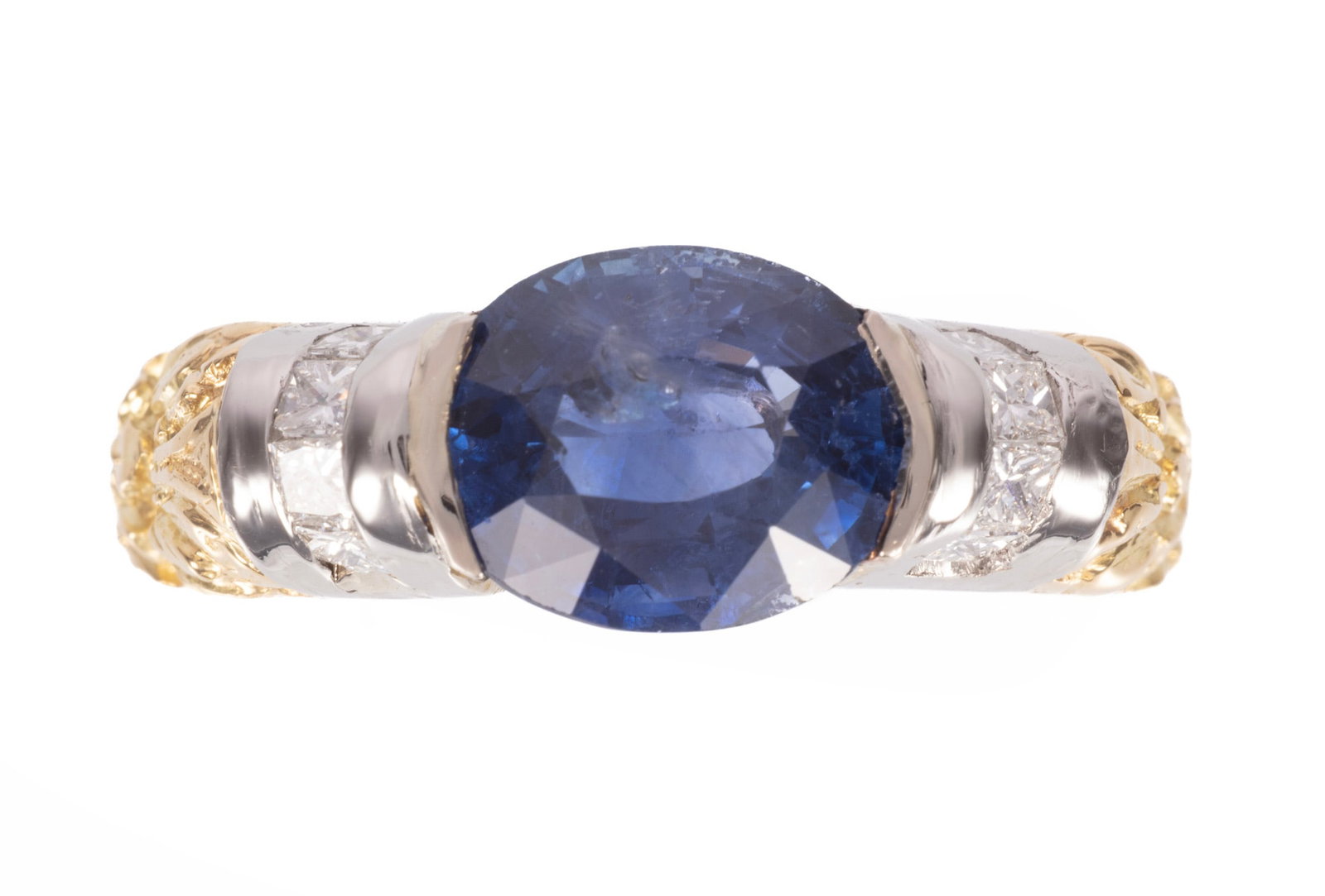 Platinum, 18 kt. Yellow Gold, 3.54 carat Sapphire and Diamond Ring: Platinum, 18 kt. Yellow Gold, Sapphire and Diamond Ring center oval mixed cut blue sapphire, wt. approx. 3.54 cts.; mounted with 8 princess cut diamonds, total wt. approx. 0.40 ct.; size 7; GGA and