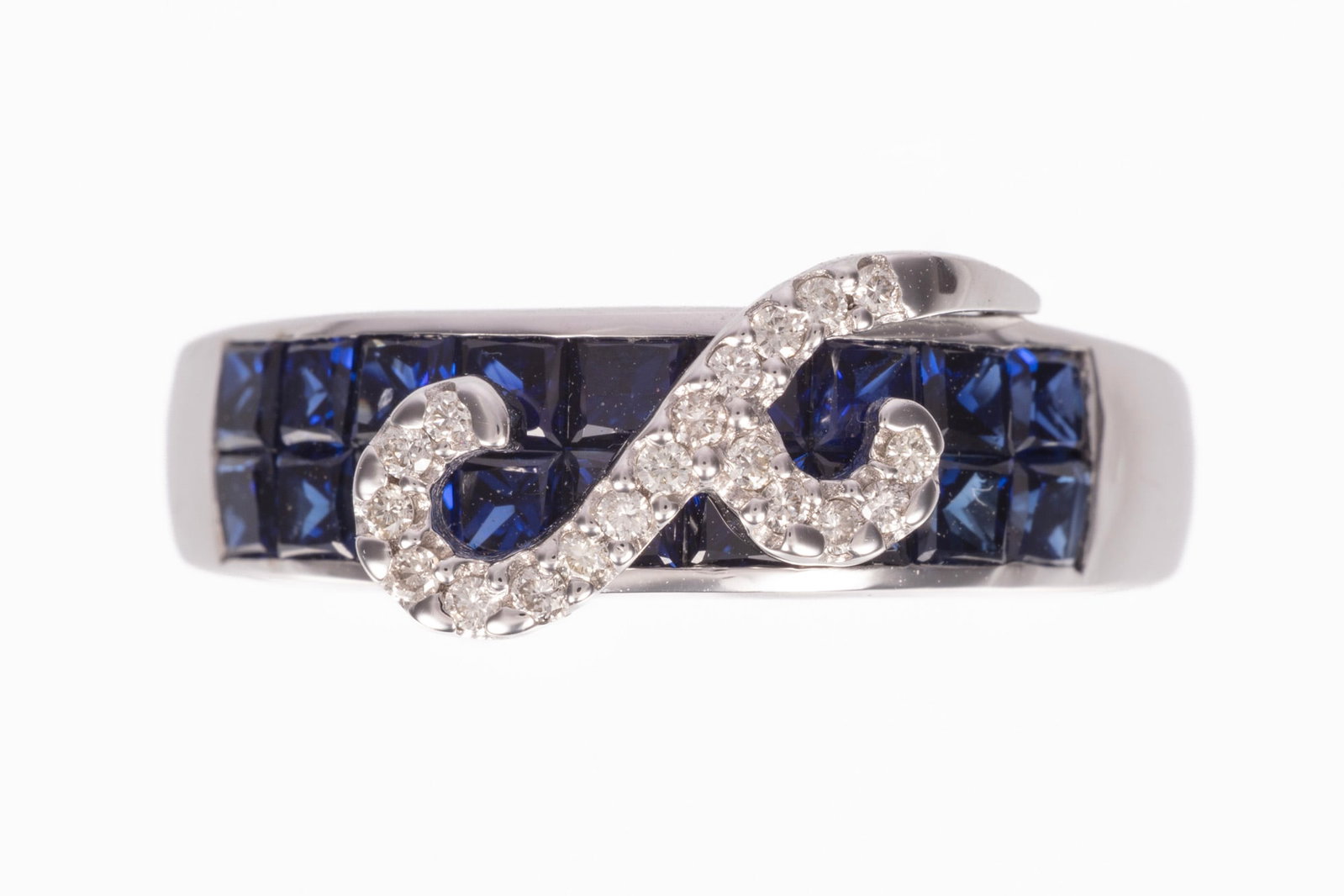 14 kt. White Gold, Sapphire and Diamond Ring: 14 kt. White Gold, Sapphire and Diamond Ring mounted with numerous channel set princess cut blue sapphires, total wt. approx. 1.30 cts.; mounted with 19 round brilliant cut diamonds, total wt.