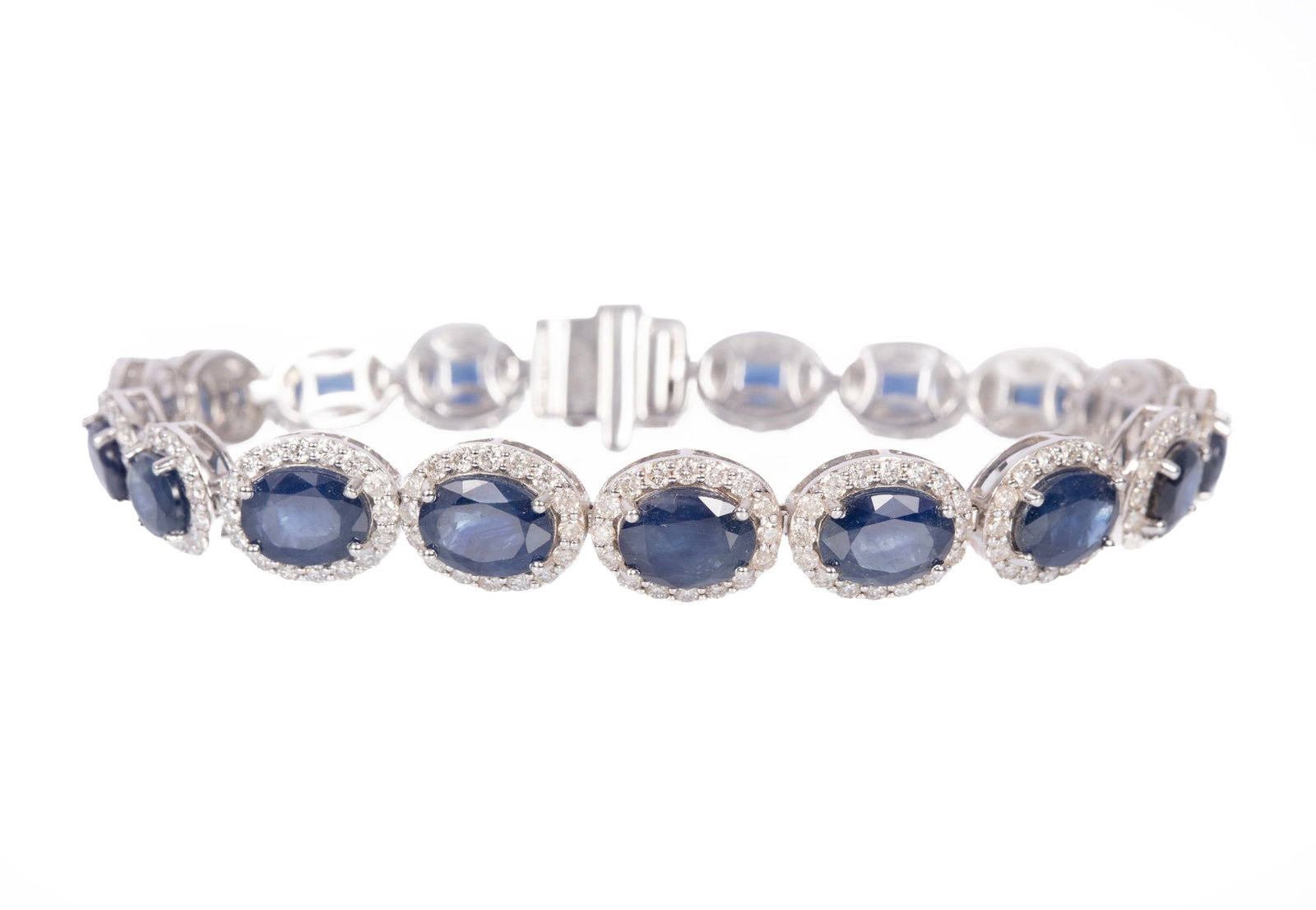 14 kt White Gold, Sapphire and Diamond Bracelet | 17.65 sapphire tcw: 14 kt White Gold, Sapphire and Diamond Bracelet mounted with 17.65 cts. of oval brilliant faceted cut sapphires; and 3.63 cts. of round briliant cut diamonds; l. 7 in.; GGA report. Please Note: