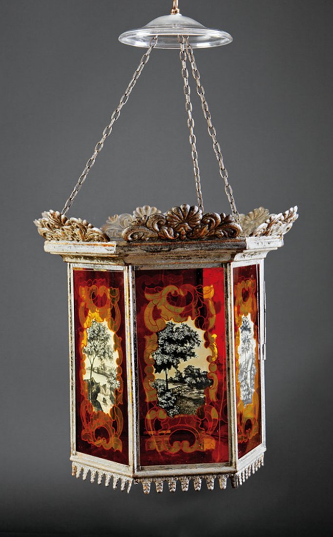 An American Tole Peinte Hexagonal Hall Lantern: An Antique American Tole Peinte Hexagonal Hall Lantern, pressed metal floral crest, original glass panes reverse painted with red ground, reserved with rural landscapes executed en grisaille, height 2