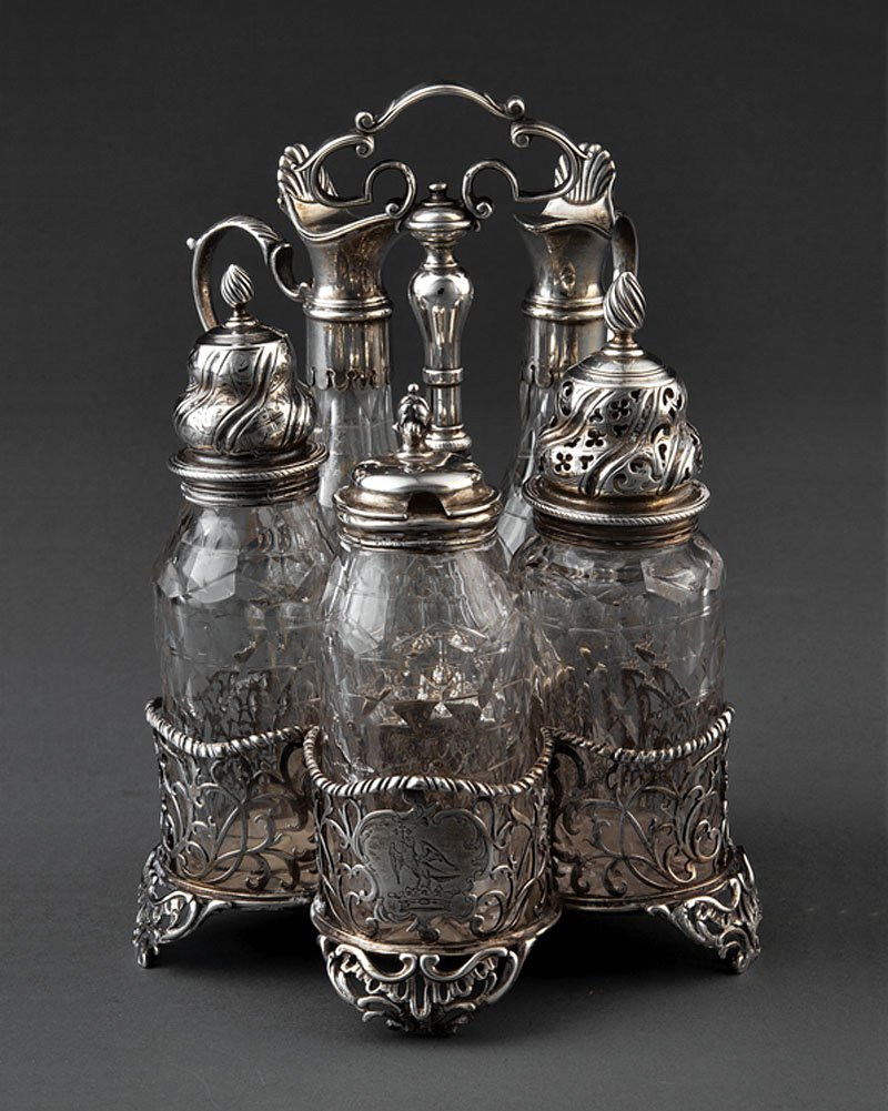 Cruet Stand, London, possibly Edward Aldridge: A George III Sterling Silver Cruet Stand, London, 1766, possibly Edward Aldridge, reticulated cinquefoil frame with gadrooned rim and reticulated feet, associated bottles, one "as is"; stand height 8 