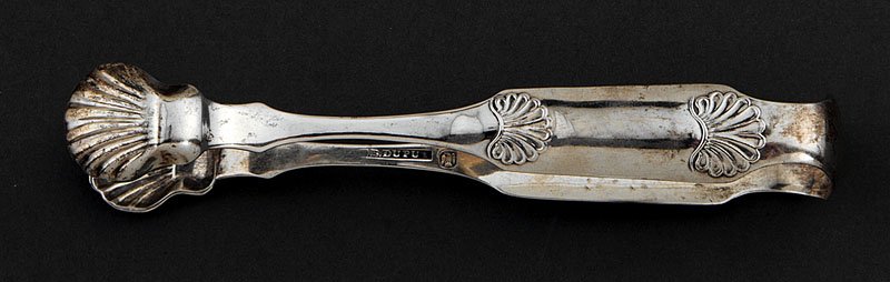 A North Carolina Coin Silver Sugar Tongs: A North Carolina Coin Silver Sugar Tongs, Bernard Dupuy, Raleigh, wc. 1828-1843, marked "B. DUPUY" in rectangle and with eagle; shell decoration, script monogram, length 6 1/2 in., weight 1.50 troy oz