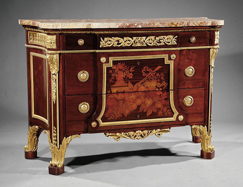 A Louis XVI-Style Gilt Bronze-Mounted Commode: A Louis XVI-Style Gilt Bronze-Mounted, Marquetry and Mahogany Commode, early 20th c., after a model by Jean-Henri Riesener, shaped marble top, three frieze drawers over two long drawers decorated with