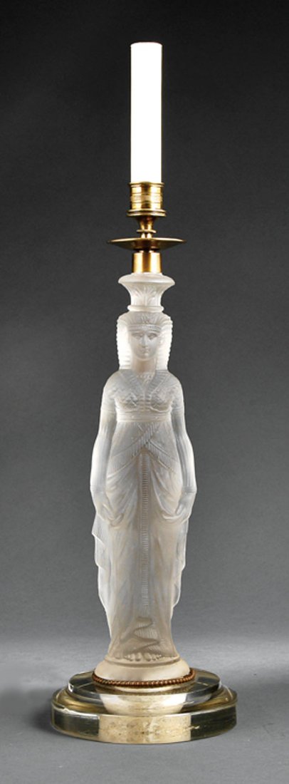 A French Art-Deco Glass Figural Candlestick: A French Art-Deco Glass Figural Candlestick, early 20th c., lacquered brass nozzle, over Egyptian figure, on molded clear glass base, now mounted as a lamp, height 17 in., diameter 5 3/4 in