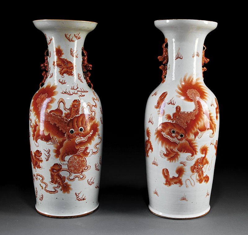 A Pair of Chinese Iron Red Porcelain Baluster Vas: A Pair of Chinese Iron Red Porcelain Baluster Vases, late 19th/early 20th c., each decorated with a Buddhist lion and pups with calligraphy on reverse, height 24 in