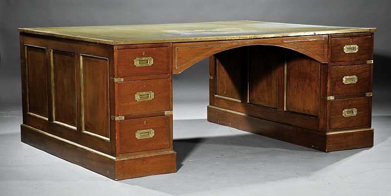 An English "Campaign" Mahogany and Brass Bound Pa: An English "Campaign" Mahogany and Brass Bound Partner's Desk, 20th c., tooled leather top, double pedestal base of three drawers on each side, blocked base, height 29 1/2 in., width 72 in., depth 54 