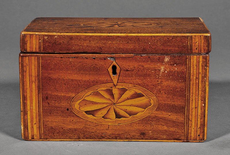A George III Mahogany Tea Caddy: A George III Mahogany Tea Caddy, inlaid with paterae and stringing, lacking interior fitting and lock, small losses, height 4 1/2 in., width 7 5/8 in., depth 4 1/8 in.. Provenance: Wellesley House Ant