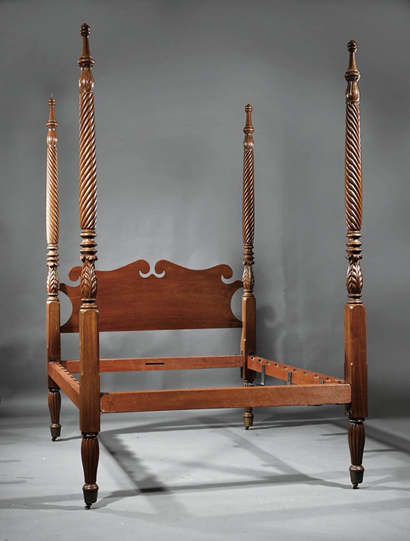 An American Classical Carved Mahogany Four Poster: An American Classical Carved Mahogany Four Poster Bed, early 19th c., acanthus leaf posts ending in flared reeded legs, scrolled headboard, straight foot board, conforming rails. Note: poplar rails, p