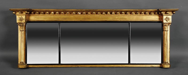 An American Classical Carved Giltwood Overmantel: An American Classical Carved Giltwood Overmantel Mirror, early 19th c., molded cornice with spherules, tripartite divided mirror plate with ebonized surround flanked by engaged Corinthian columns, hei