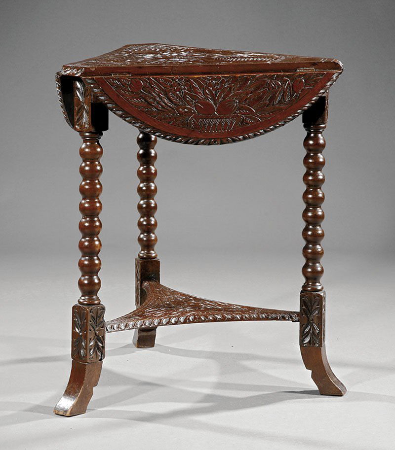 An Elizabethan-Style Carved Oak Handkerchief Tabl: An Elizabethan-Style Carved Oak Handkerchief Table, top with molded drop leaves, turned uprights, incurvate stretcher shelf, flared feet, height 27 1/2 in., diameter 26 1/2 in