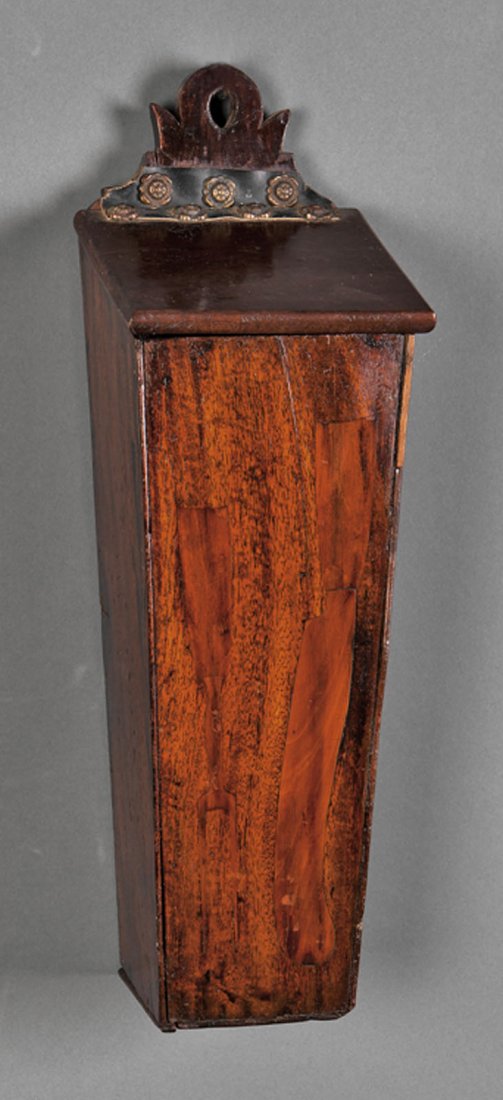 An American Carved Mahogany Hanging Knife: An Antique American Carved Mahogany Hanging Knife Box, the scrolled and pierced pediment over square tapered box with inlay of carving knife and fork, lid hinged with leather attached with flower head