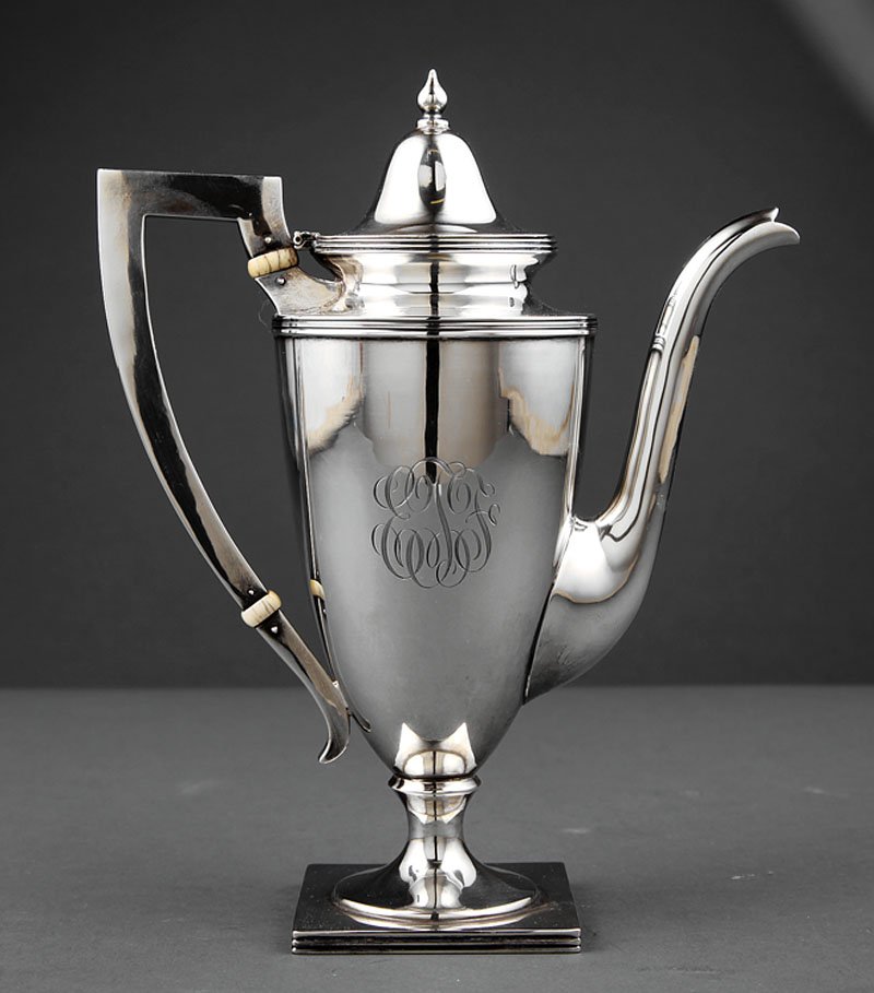 A Sterling Silver Coffee Pot: A Small Sterling Silver Coffee Pot, S. A. Maqueen & Co., plain classical urn form on a square footed pedestal base, reeded borders and hinged cover, engraved script monogram, height 9 1/2 in., weight 