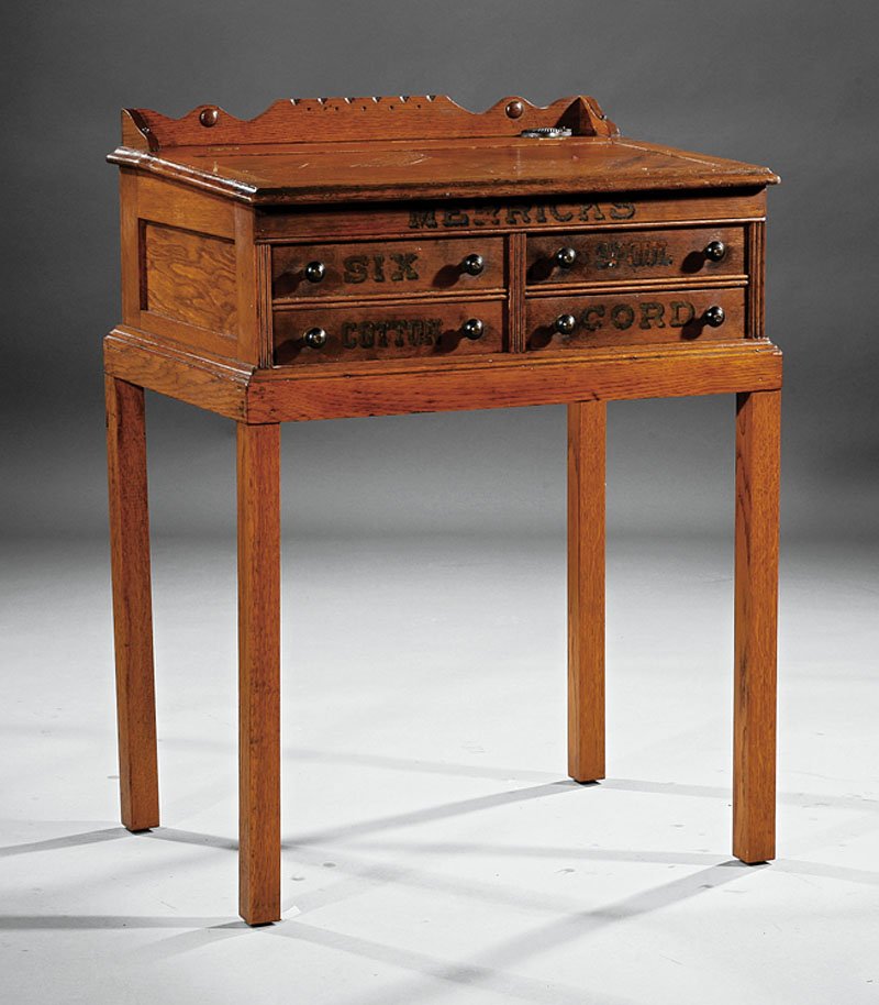 An American Carved Oak Merrick's Spool Cabinet De: An American Carved Oak Merrick's Spool Cabinet Desk, late 19th c. and later, galleried rail, lift top with mirror, drawers below on conforming later stand, height 37 1/2 in., width 28 in., depth 20 in