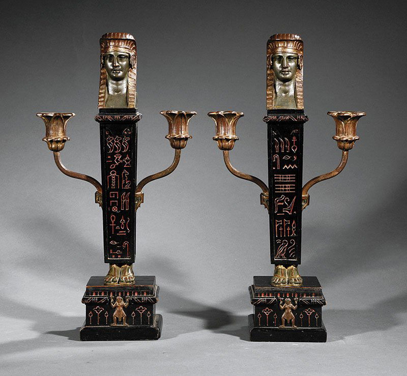Ebonized, Gilt Bronze-Mounted Candlesticks: A Pair of Egyptian Revival Ebonized, Gilt Bronze-Mounted Three-Light Candlesticks, 19th c., tapered obelisk standard, with incised hieroglyphs, flanked by floriform arms, height 16 3/4 in., width 8 1/