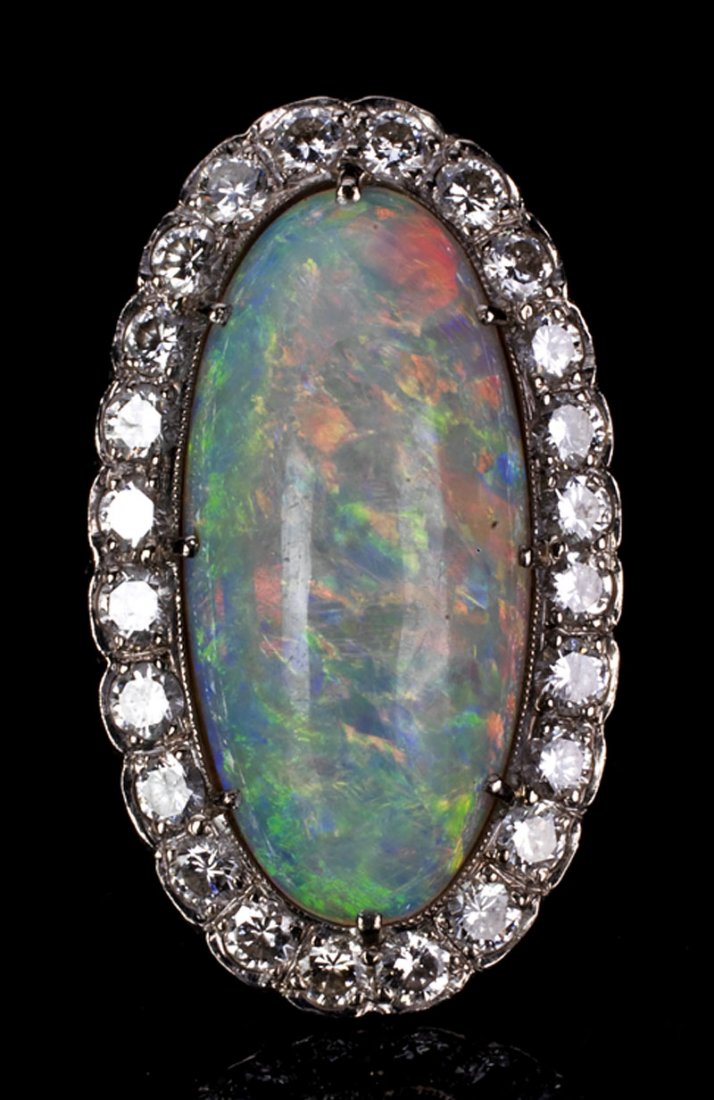 18 kt. White Gold, Opal and Diamond Cluster Ring: A Vintage 18 kt. White Gold, Opal and Diamond Cluster Ring, set with a fine Australian oval opal and 24 brilliant cut diamonds, J-K, SI2-I2, approx. 1 ct. total
