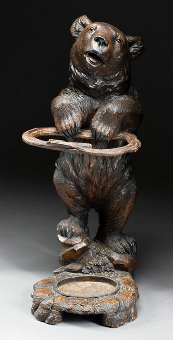 Black Forest Carved Walnut Figural Umbrella Stand: An Antique Black Forest Carved Walnut Figural Umbrella Stand, 19th c., in the form of a bear with glass eyes, naturalistic base, drip pan, height 39 1/2 in., width 16 in., depth 22 in
