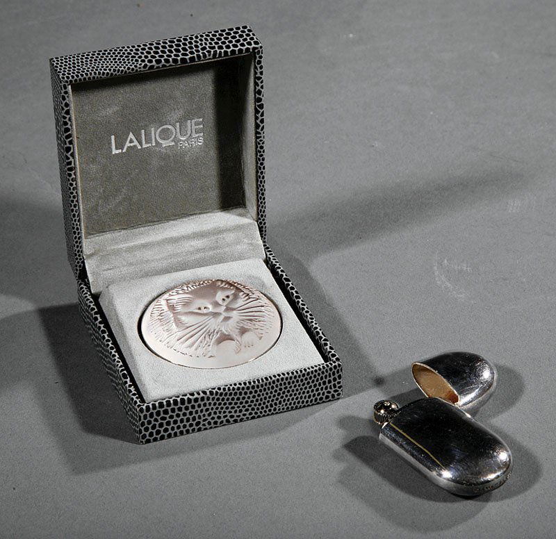 Elsa Peretti for Tiffany & Co. Sterling Lighter: An Elsa Peretti for Tiffany & Co. Sterling Silver "Bean" Lighter, length 2 3/8 in.; together with a Lalique molded crystal brooch, diameter 1 7/8 in